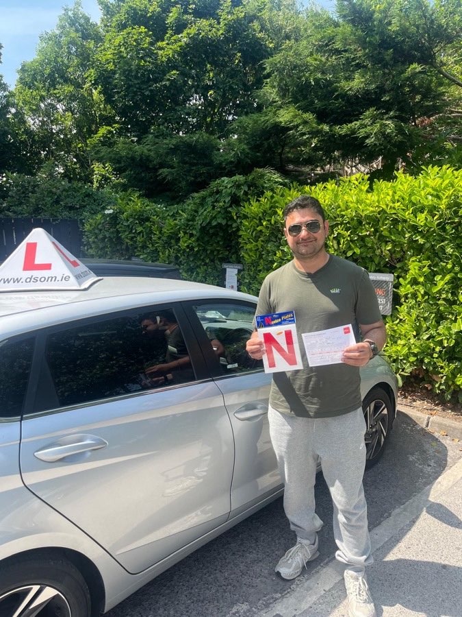 Learner driver celebrating a driving test pass with Dundrum School of Motoring